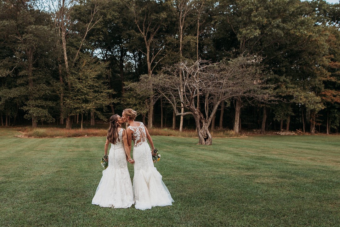 Rustic, elegant early fall wedding in Sabillasville, Maryland LGBTQ+ weddings lesbian wedding two brides long white dresses outdoors South Carolina Southern September wedding sunflowers