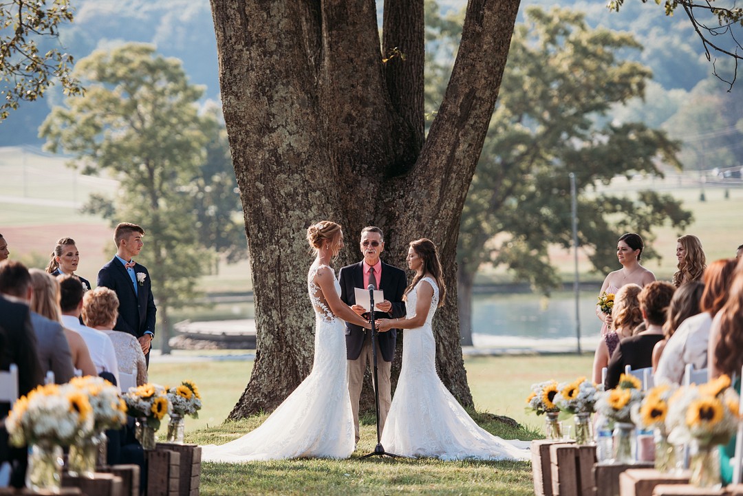 Rustic, elegant early fall wedding in Sabillasville, Maryland LGBTQ+ weddings lesbian wedding two brides long white dresses outdoors South Carolina Southern September wedding sunflowers vows
