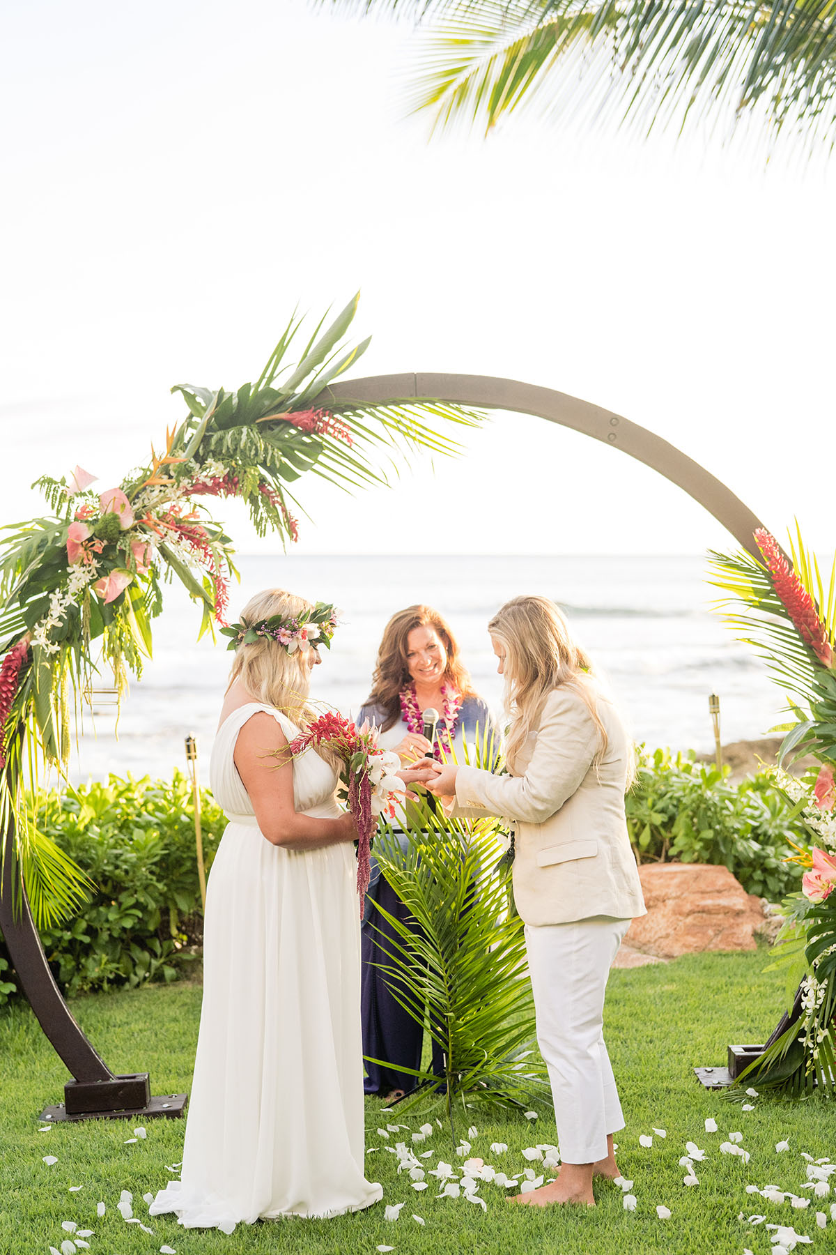 Colorful, floral tropical beach destination wedding in Makaha, Hawaii LGBTQ+ weddings lesbian wedding two brides birds of paradise vows