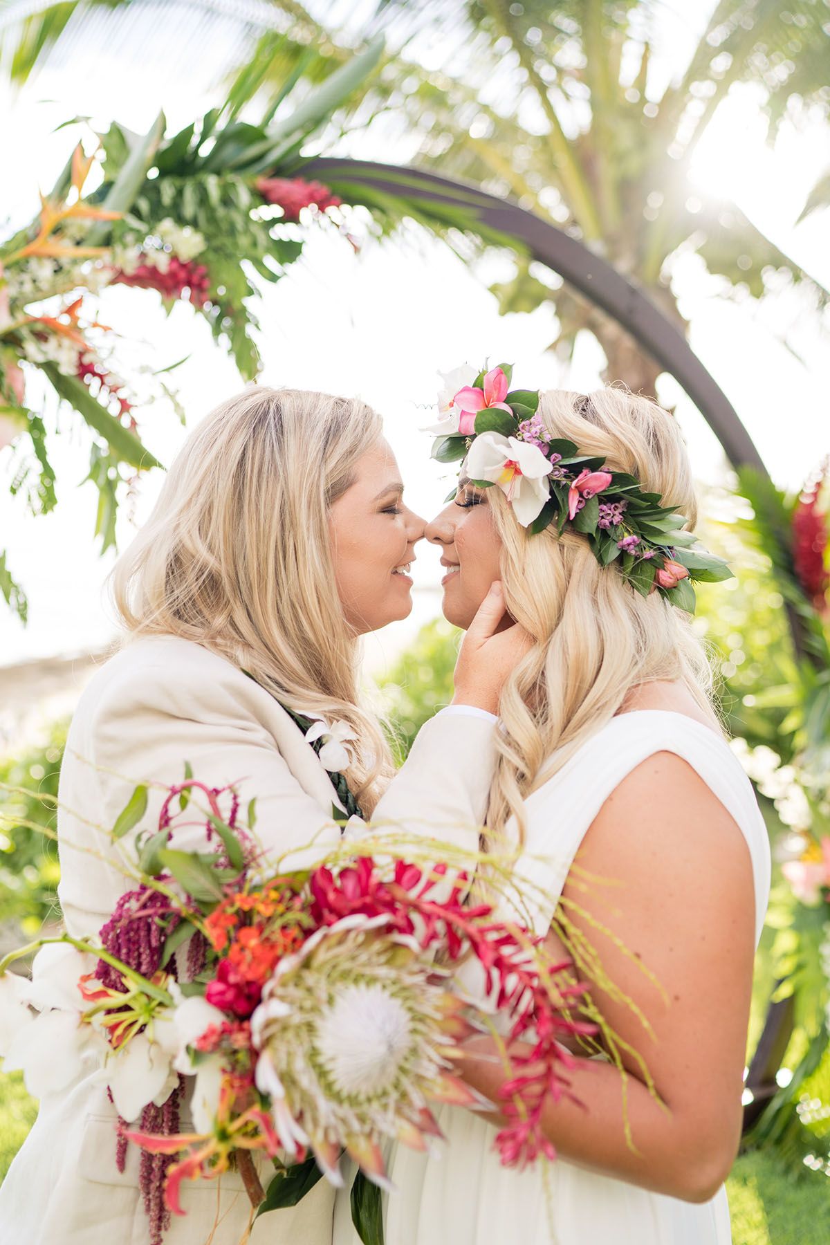 Colorful, floral tropical beach destination wedding in Makaha, Hawaii LGBTQ+ weddings lesbian wedding two brides birds of paradise