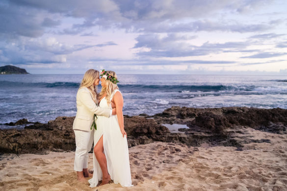 Colorful, floral tropical beach destination wedding in Makaha, Hawaii LGBTQ+ weddings lesbian wedding two brides birds of paradise kiss ocean