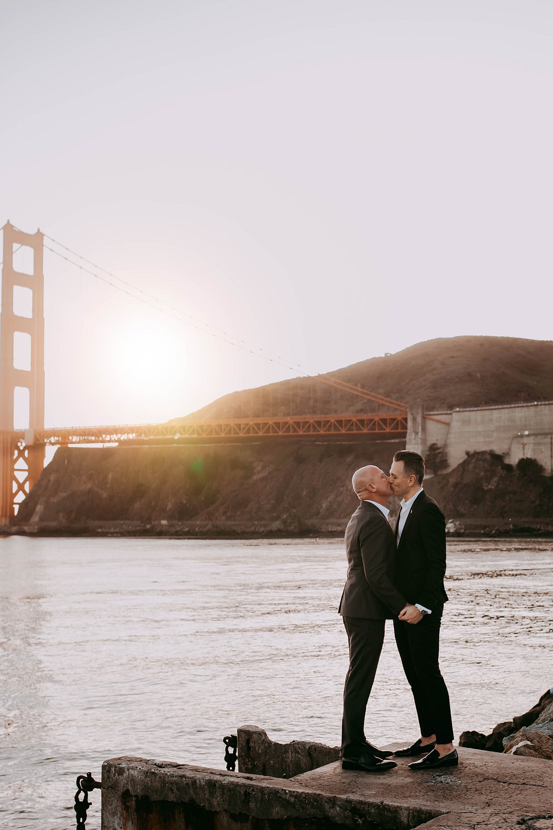 Beach anniversary photos in San Francisco, California LGBTQ+ weddings photo shoot two grooms Golden Gate