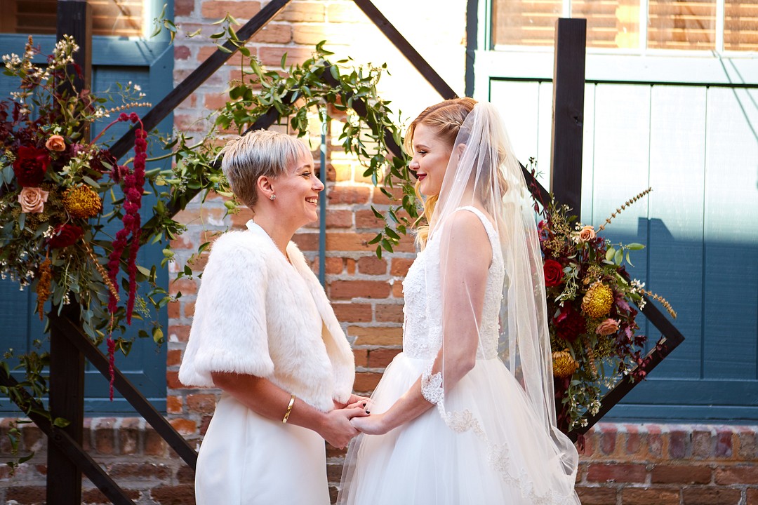 Modern romantic fall wedding inspiration in Charleston, South Carolina LGBTQ+ weddings styled shoot two brides lesbian wedding red deep hues vintage