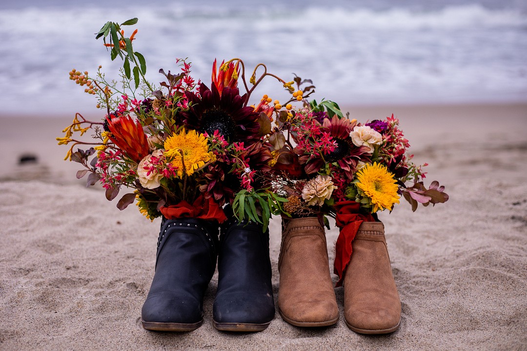 Cliffside fall El Matador Beach proposal with romantic picnic LGBTQ+ engagements weddings proposals surprise California Malibu two brides shoes flowers bouquets