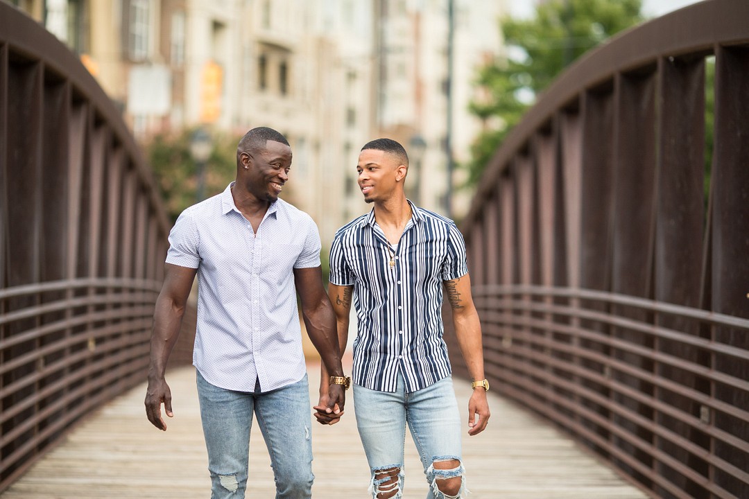 Engagement photos at the Millennium Gate in Atlanta, Georgia LGBTQ+ weddings engagements two grooms museum