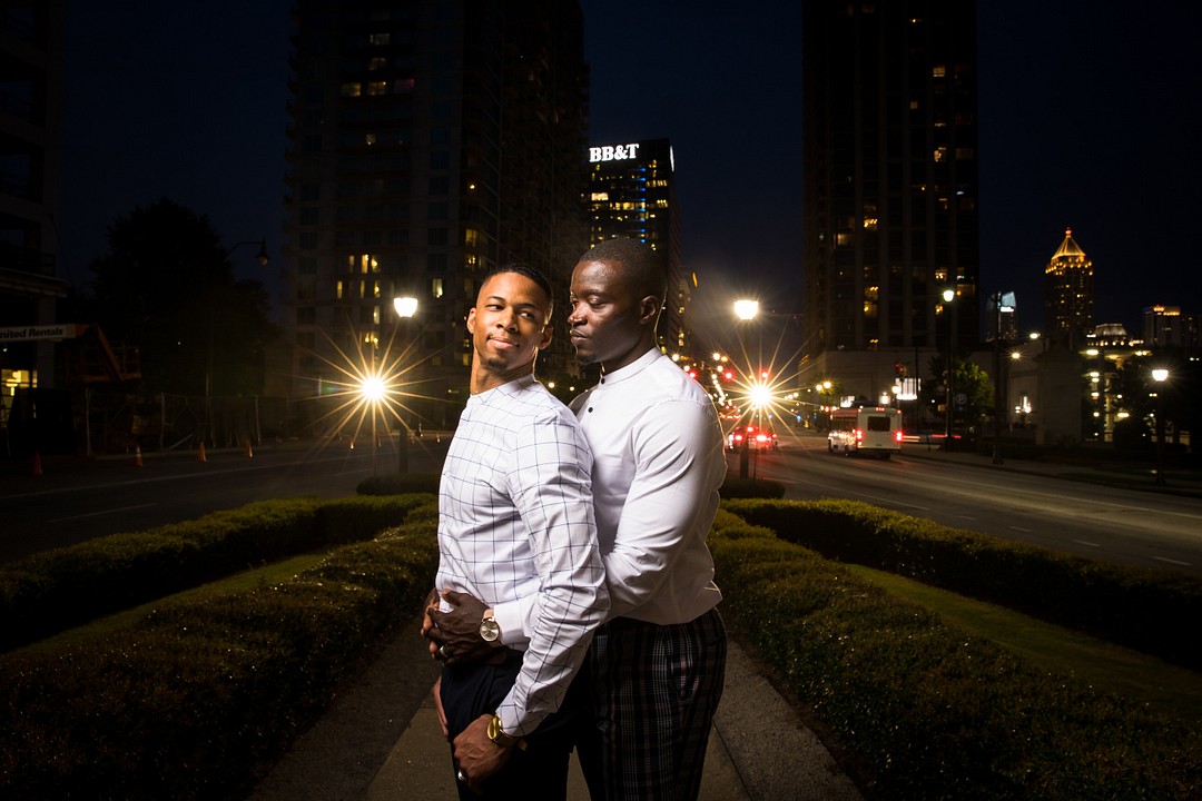 Engagement photos at the Millennium Gate in Atlanta, Georgia LGBTQ+ weddings engagements two grooms museum