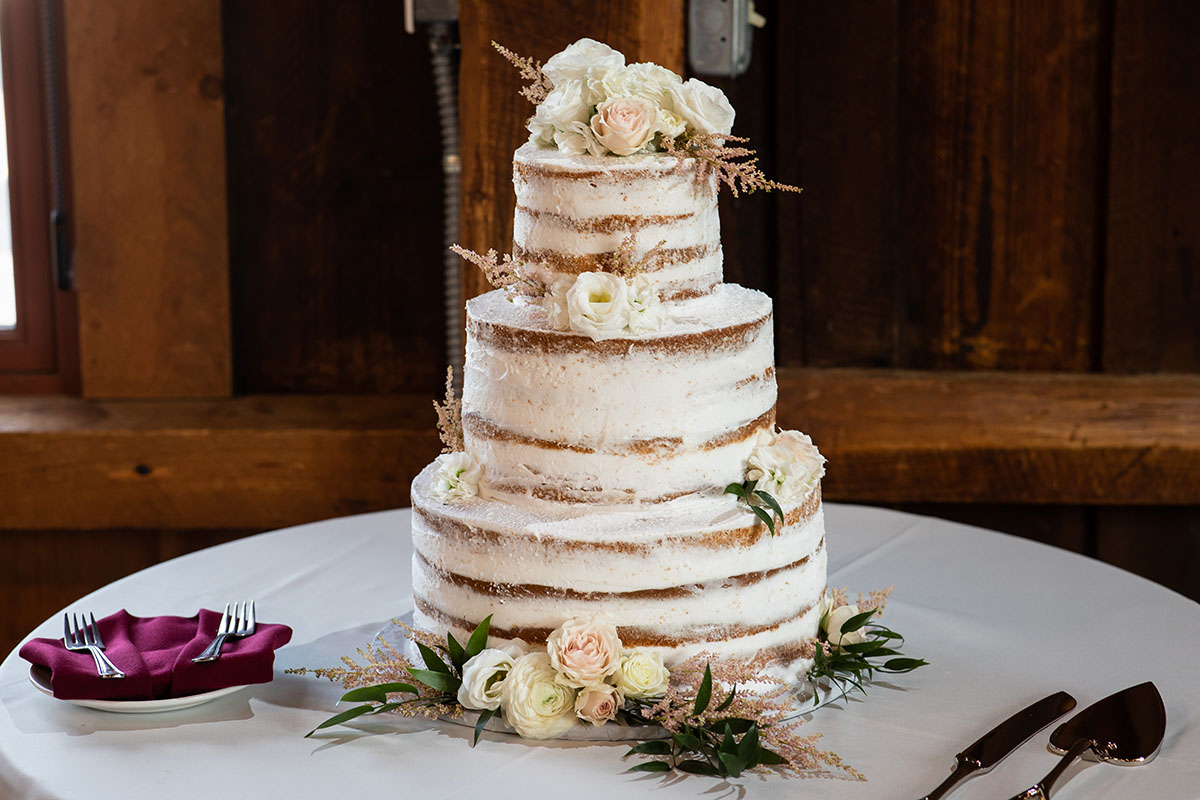 Rustic mountain wedding at The Red Barn at Hampshire College LGBTQ+ weddings two brides Amherst Massachusetts romantic cozy cake