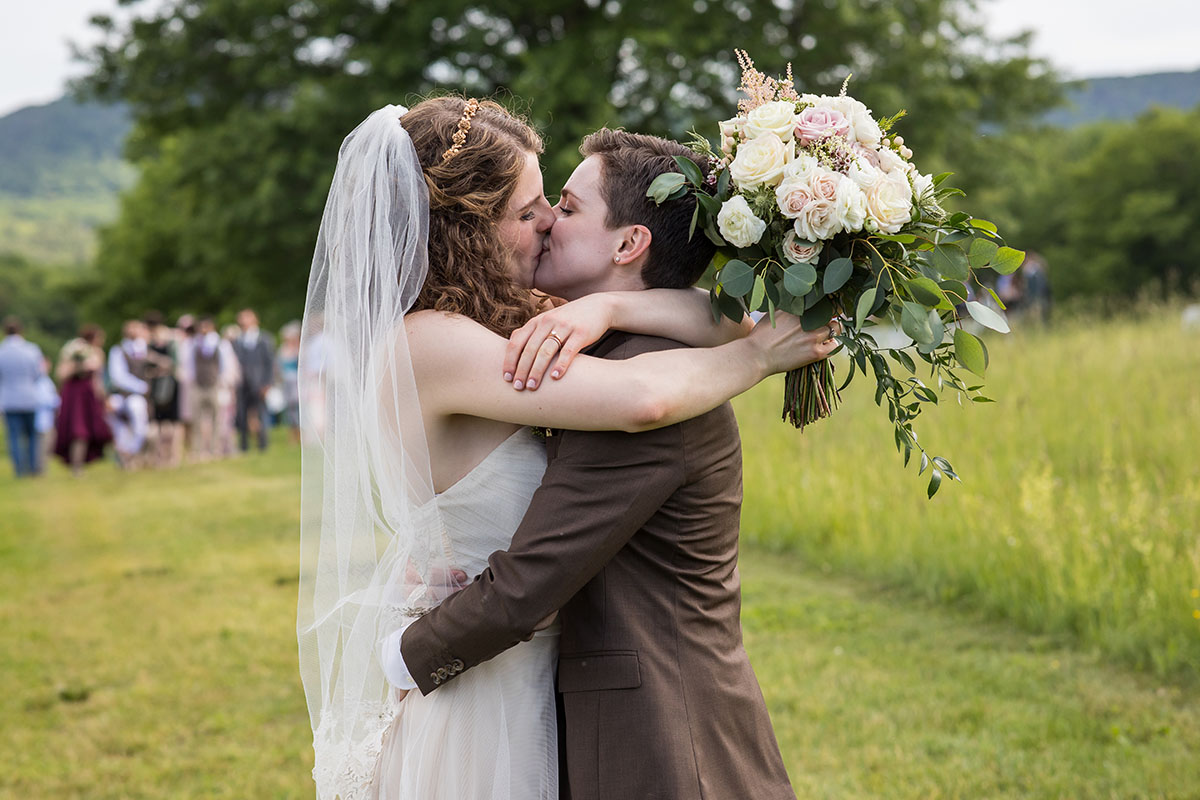Rustic mountain wedding at The Red Barn at Hampshire College LGBTQ+ weddings two brides Amherst Massachusetts romantic cozy kiss