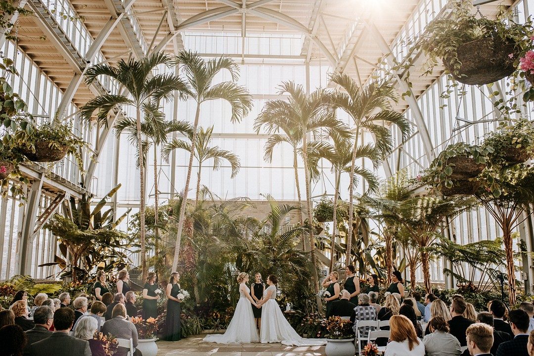 Botanical, tropical fall greenhouse wedding in St. Louis, Missouri LGBTQ+ weddings lesbian wedding two brides white dresses succulents nature greenery vows
