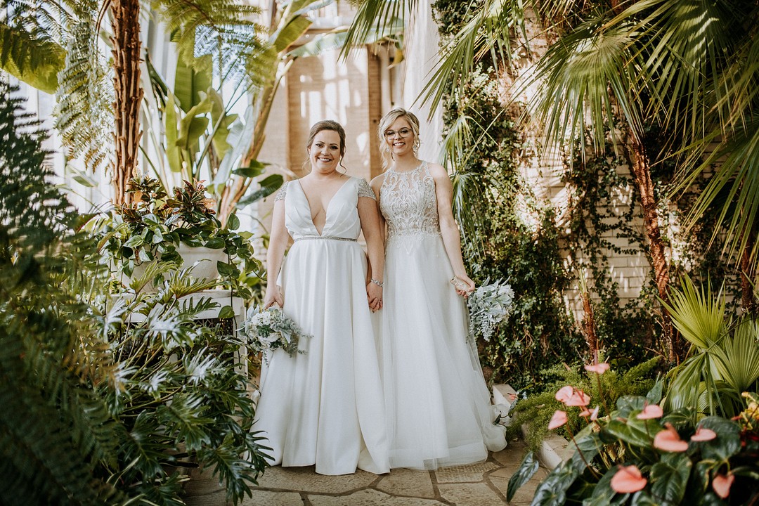 Botanical, tropical fall greenhouse wedding in St. Louis, Missouri LGBTQ+ weddings lesbian wedding two brides white dresses succulents nature greenery