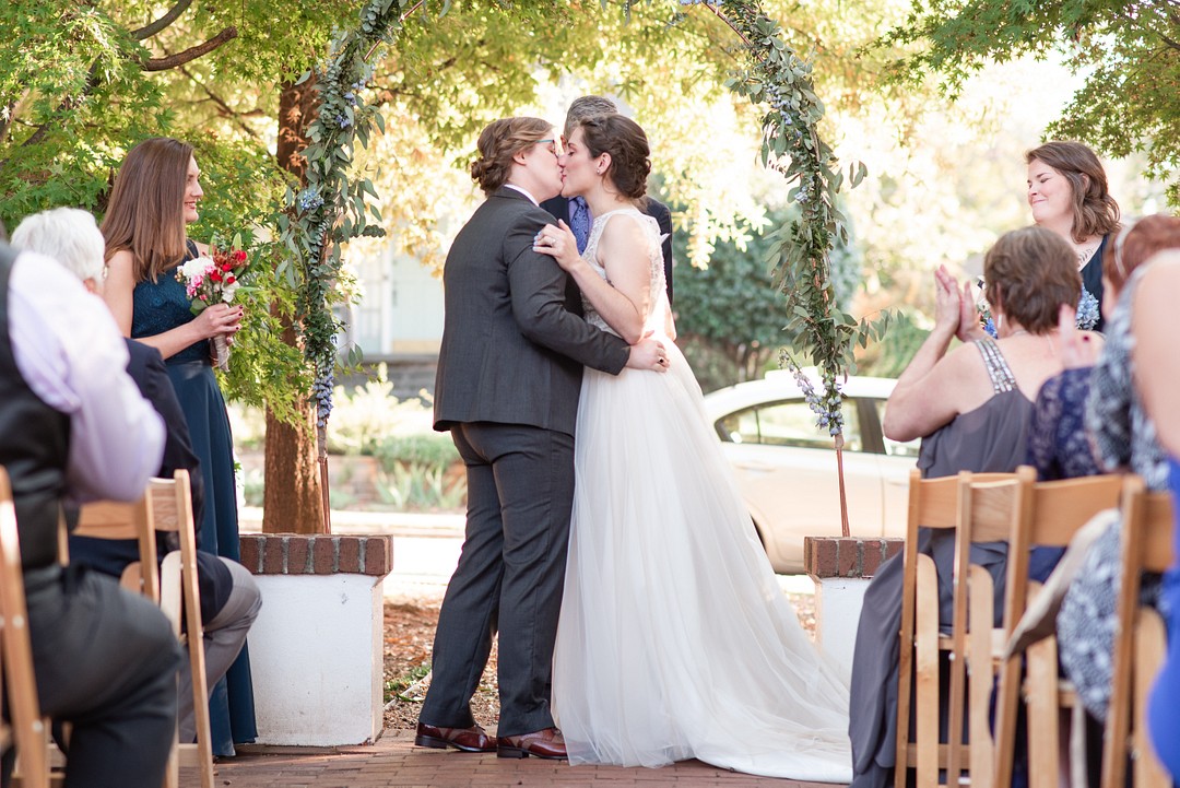 Outdoor DIY fall wedding at the Solarium in Decatur, Georgia two brides LGBTQ+ weddings lesbian wedding succulents nature do it yourself kiss