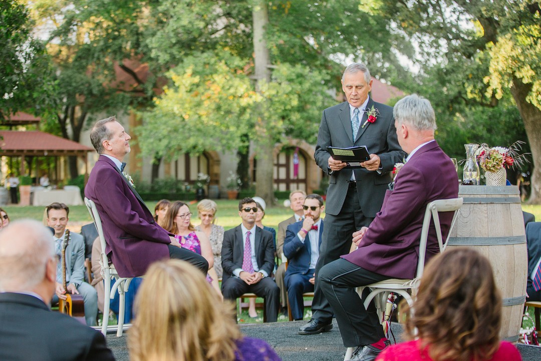 After 20 years, two grooms celebrate with whimsical winery wedding LGBTQ+ weddings aerialist gay wedding purple tux gold glitter tux fall California wedding wine country vows
