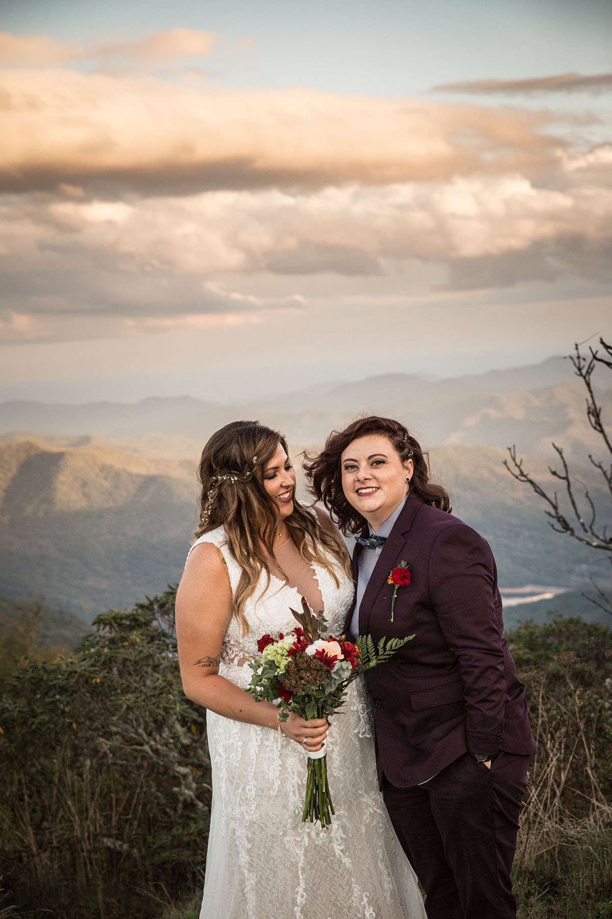 Fall golden hour mountain elopement with dog attendants LGBTQ+ weddings mountaintop queer wedding same-sex wedding burgundy tux white lace dress intimate small