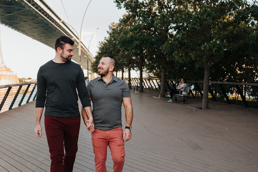 Urban summer engagement photos in Philadelphia, Pennsylvania LGBTQ+ weddings two grooms city engaged holding hands