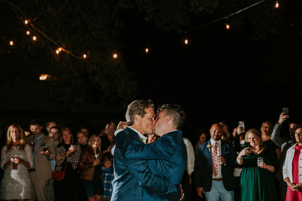 Lakeside sunset fall wedding with fireworks sendoff LGBTQ+ weddings gay wedding Texas dance