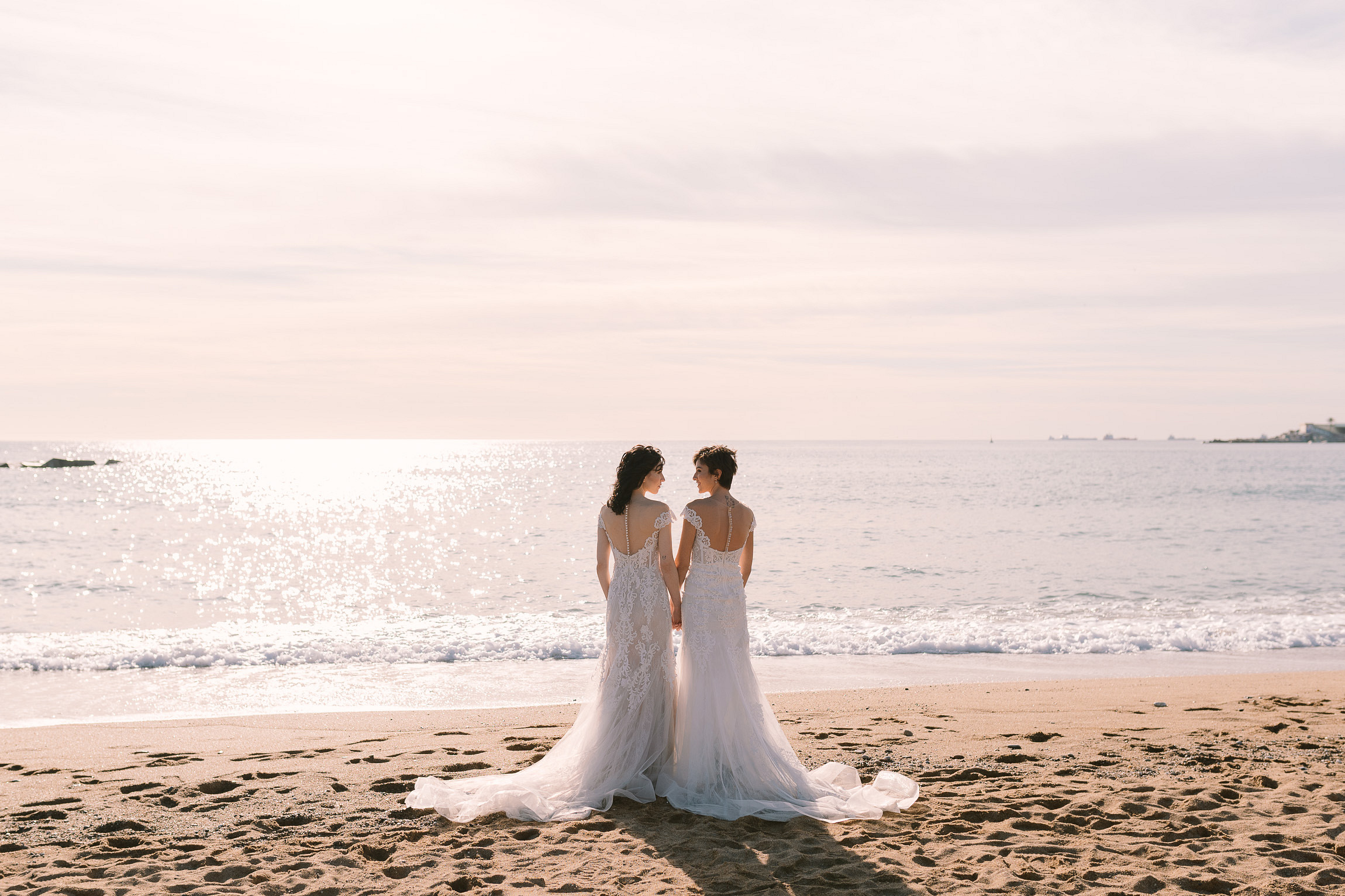Romantic winter beach wedding in Barcelona, Spain LGBTQ+ weddings destination elopement two brides lesbian