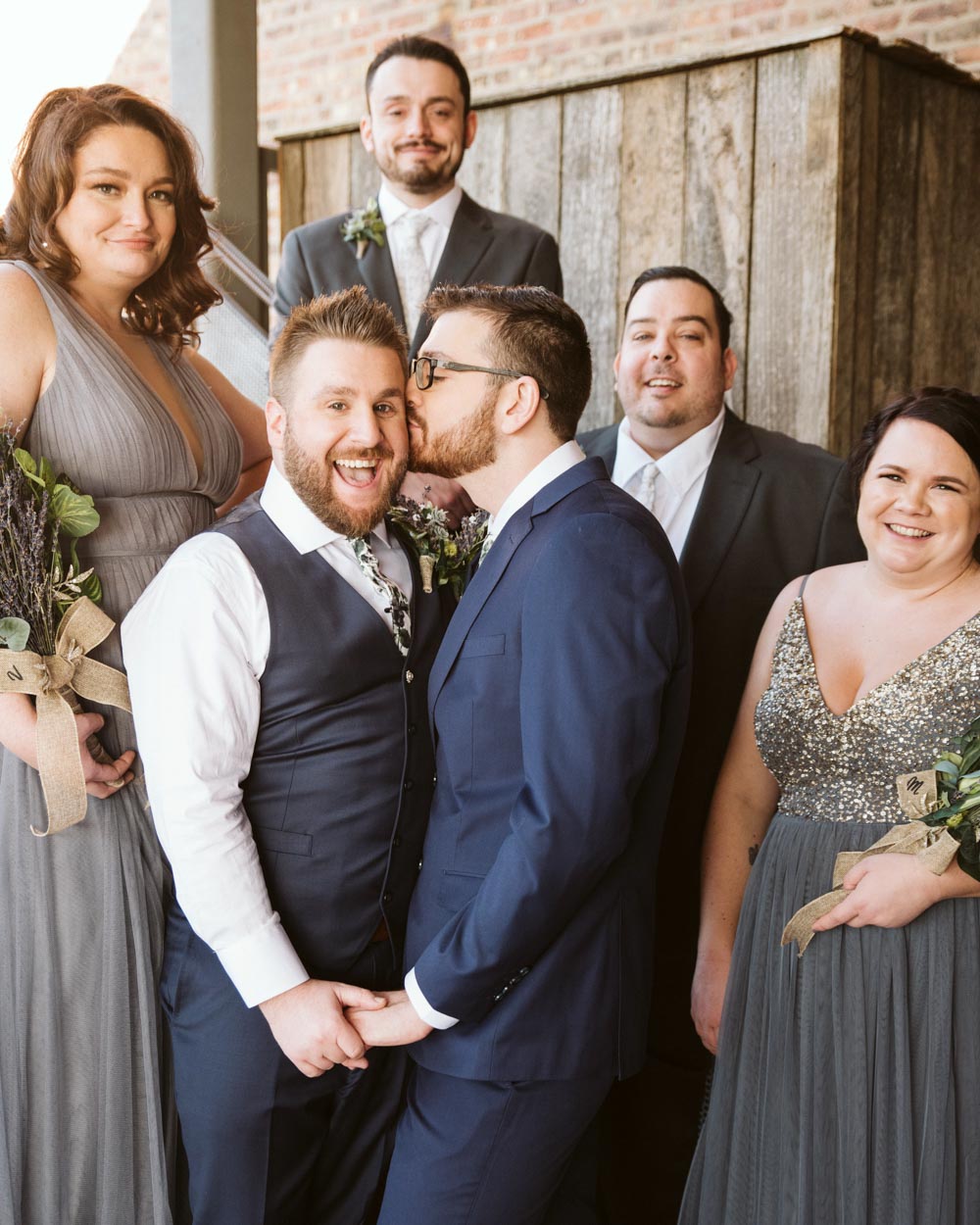 David + Andrew: Midwestern Pride Wedding Giveaway winners marry Photo Glass & Grain Photography published on Equally Wed, the world's leading LGBTQ+ wedding magazine grooms with wedding party