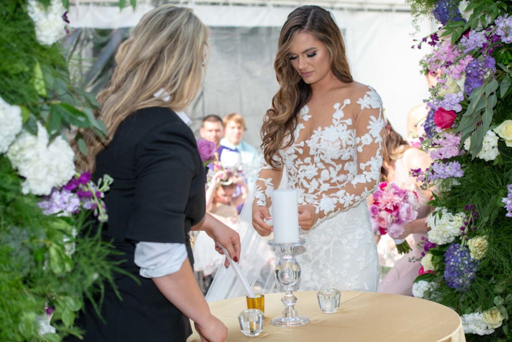 Angelina + Krista: Upscale glamorous lesbian wedding at the renowned Versace mansion in Miami Beach, Florida Suzanne Delawar Studios couple lighting candle ceremony ritual