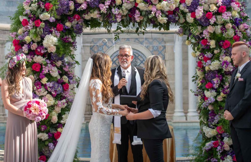Angelina + Krista: Upscale glamorous lesbian wedding at the renowned Versace mansion in Miami Beach, Florida Suzanne Delawar Studios ceremony flower arch flower crowns