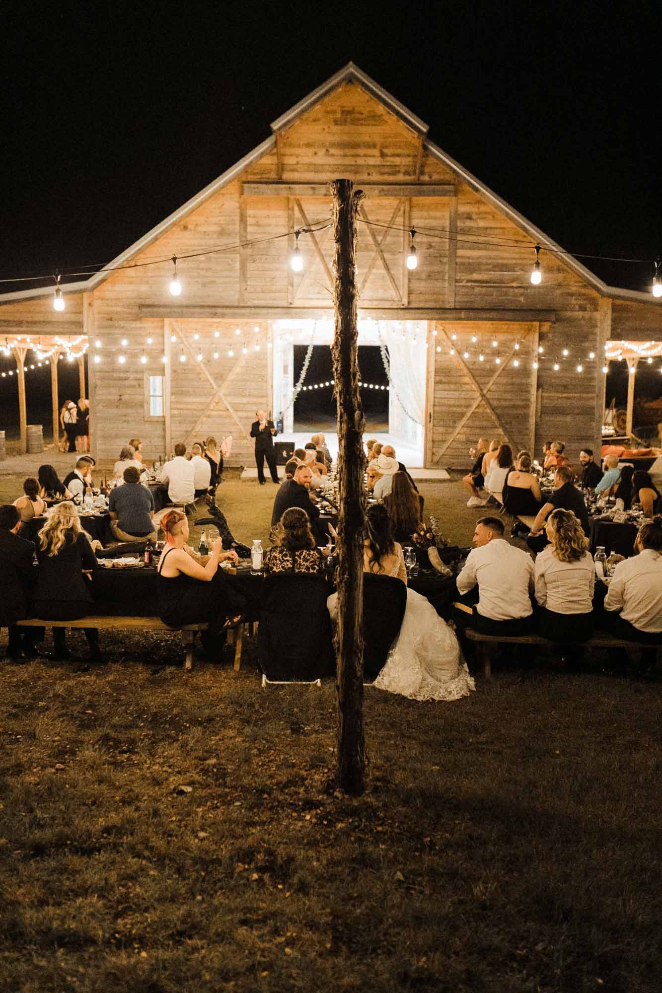 Beautifully gothic Texas wedding with creative details, photo by Leah Thomason Photography, featured on Equally Wed, the LGBTQ+ wedding magazine barn outdoor wedding reception