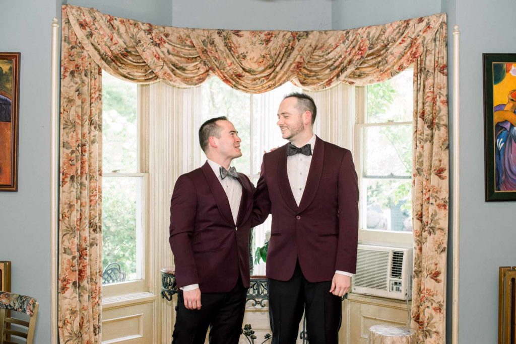 LGBTQ+ wedding with two grooms Brian + Brett: Hudson Valley garden wedding with shades of purple Upasana Mainali Photography burgundy suit jackets