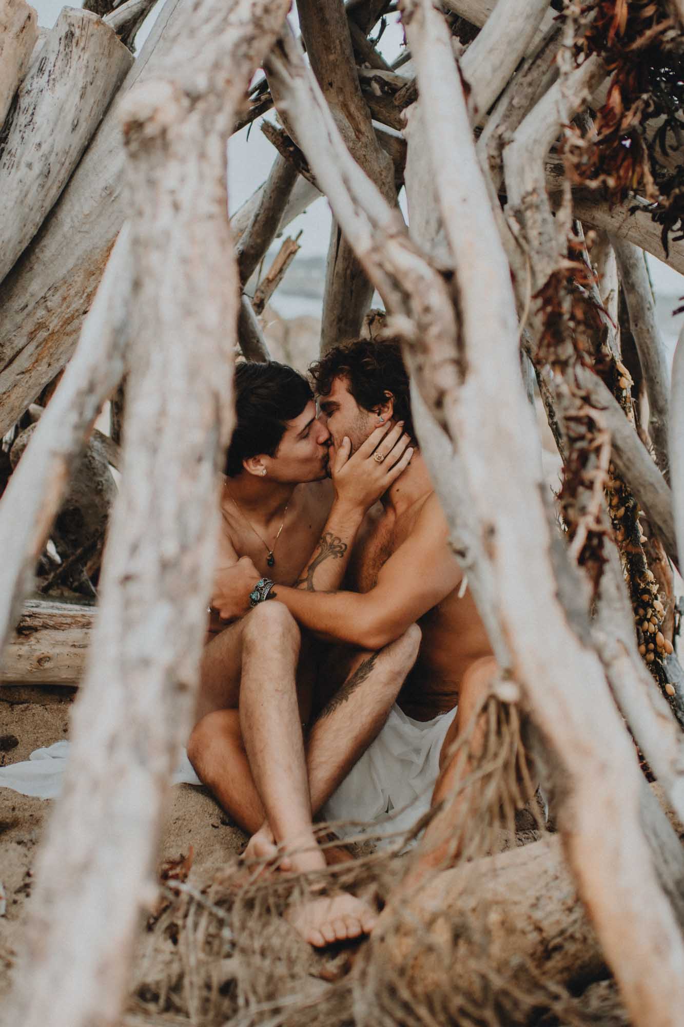 Mermen in love beach photoshoot, photos by Flora Gibson Photography, published on Equally Wed, the world's leading LGBTQ+ wedding magazine and vendor directory
