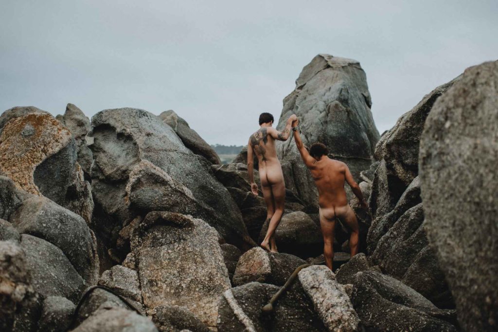 Mermen in love beach photoshoot, photos by Flora Gibson Photography, published on Equally Wed, the world's leading LGBTQ+ wedding magazine and vendor directory