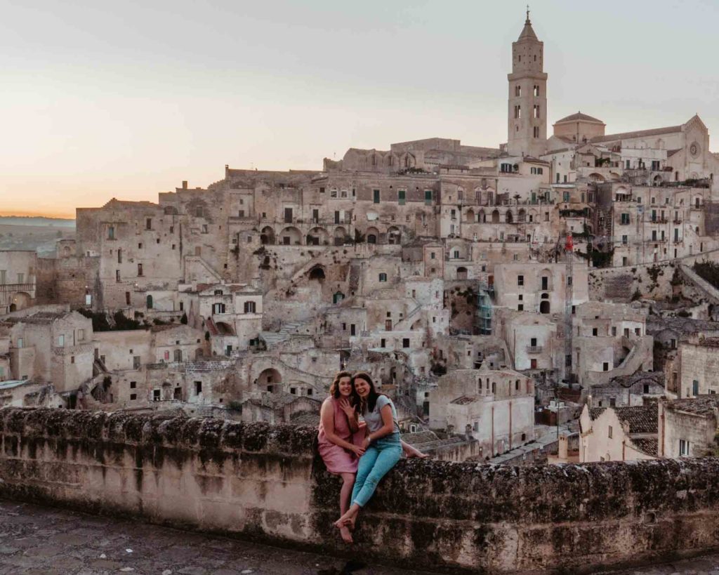 LGBTQ+ sunset proposal in Matera, Italy image description: two women smiling after one proposed to the other