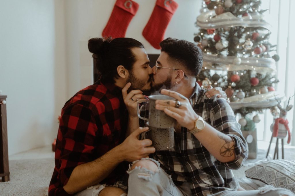 Iowa home photoshoot turned Christmas engagement feature on Equally Wed, the LGBTQ+ wedding magazine. Photo by Silk & Thorn. keywords: gay, engayged, Buffalo plaid shirts, fireplace, Christmas proposal, men in love