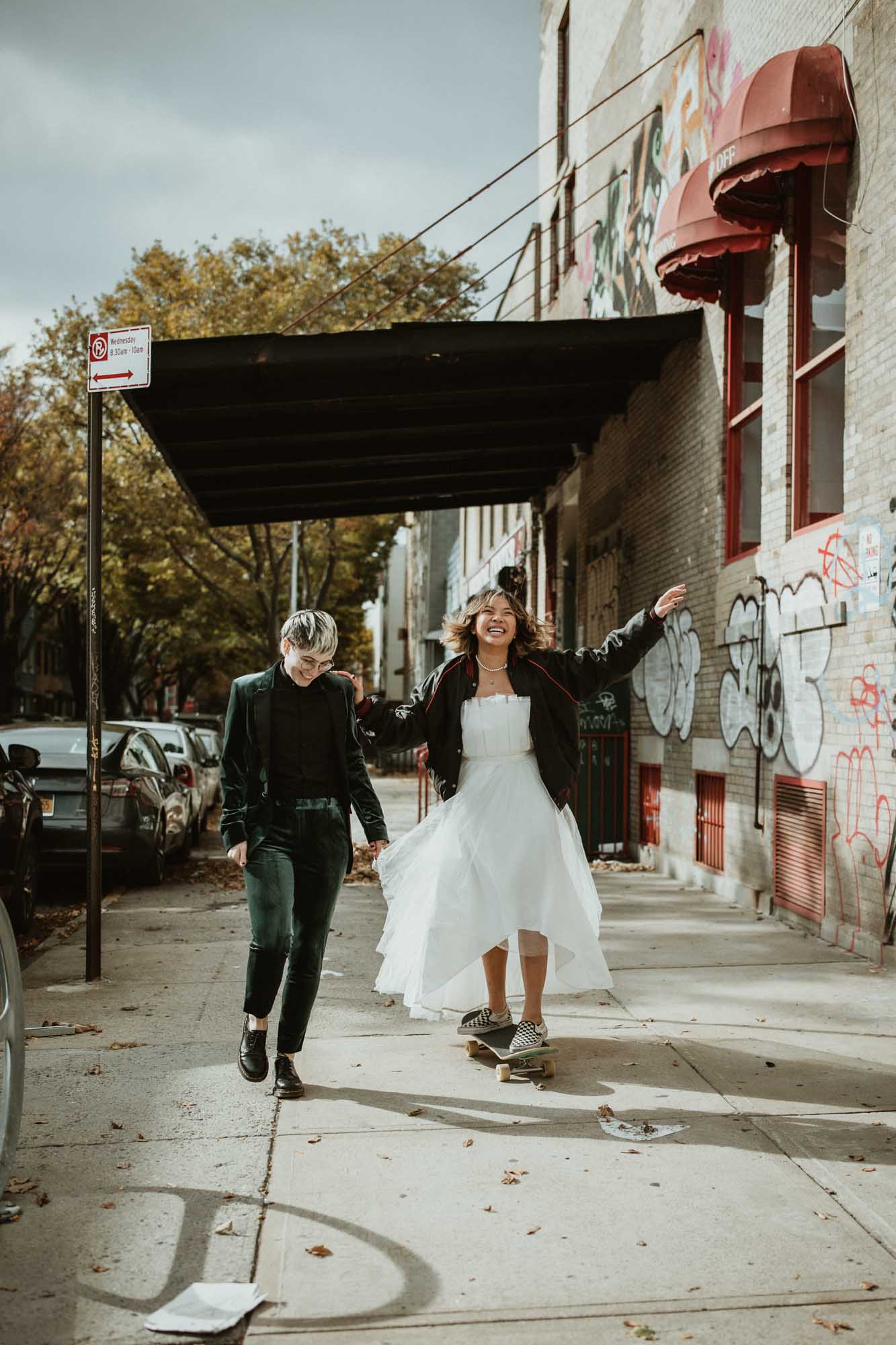 Outdoor Brooklyn microwedding styled shoot | Photography by Lucie B Photography | Featured on Equally Wed, the world's leading LGBTQ+ wedding magazine | LGBTQ+ couple celebrating their wedding with shoot in the streets, skateboard, leather jacket