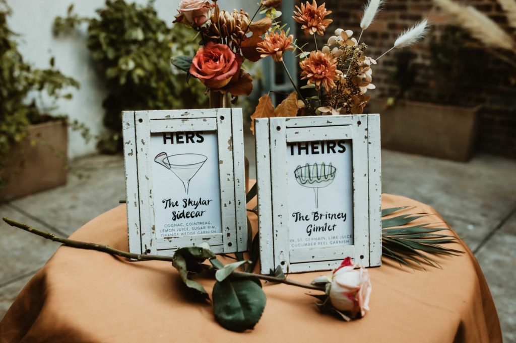 Outdoor Brooklyn microwedding styled shoot | Photography by Lucie B Photography | Featured on Equally Wed, the world's leading LGBTQ+ wedding magazine | signature cocktail signs HERS and THEIRS