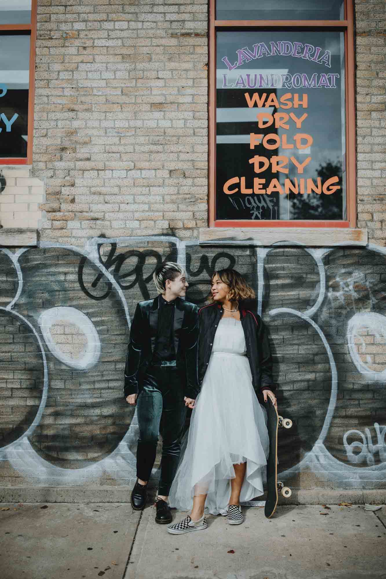 Outdoor Brooklyn microwedding styled shoot | Photography by Lucie B Photography | Featured on Equally Wed, the world's leading LGBTQ+ wedding magazine | LGBTQ+ couple celebrating their wedding with shoot in the streets, skateboard, leather jacket