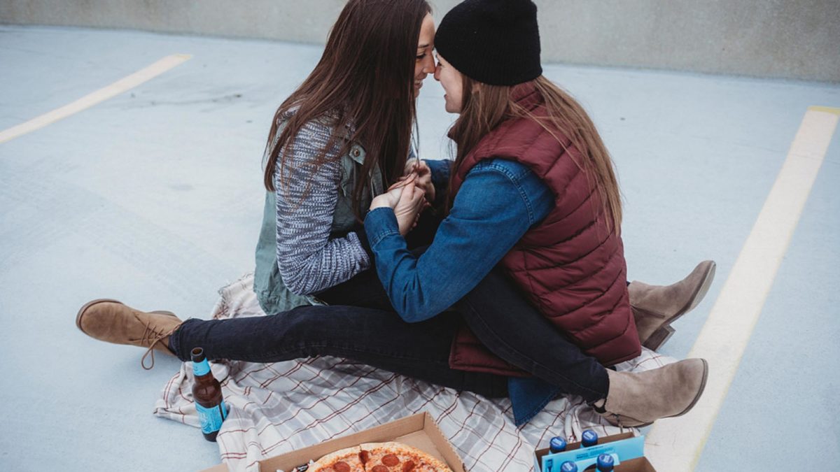 Casual rooftop engagement session with pizza and beer