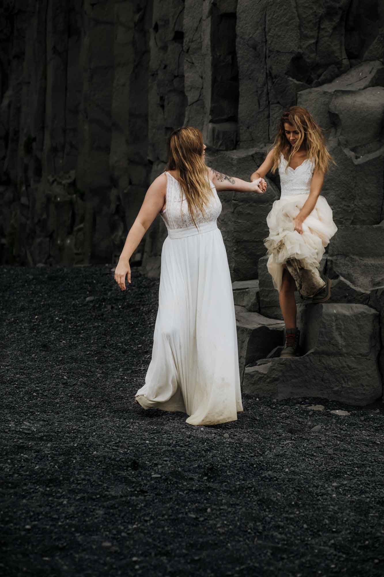 After an 18-month engagement, Cassidy and Hannah traveled from their home in West Hartford, Connecticut, to Iceland for an epic elopement. Their photographer Allie Dearie captured images of their love while the couple spent time together under massive cascading waterfalls and on the dark and moody beach.