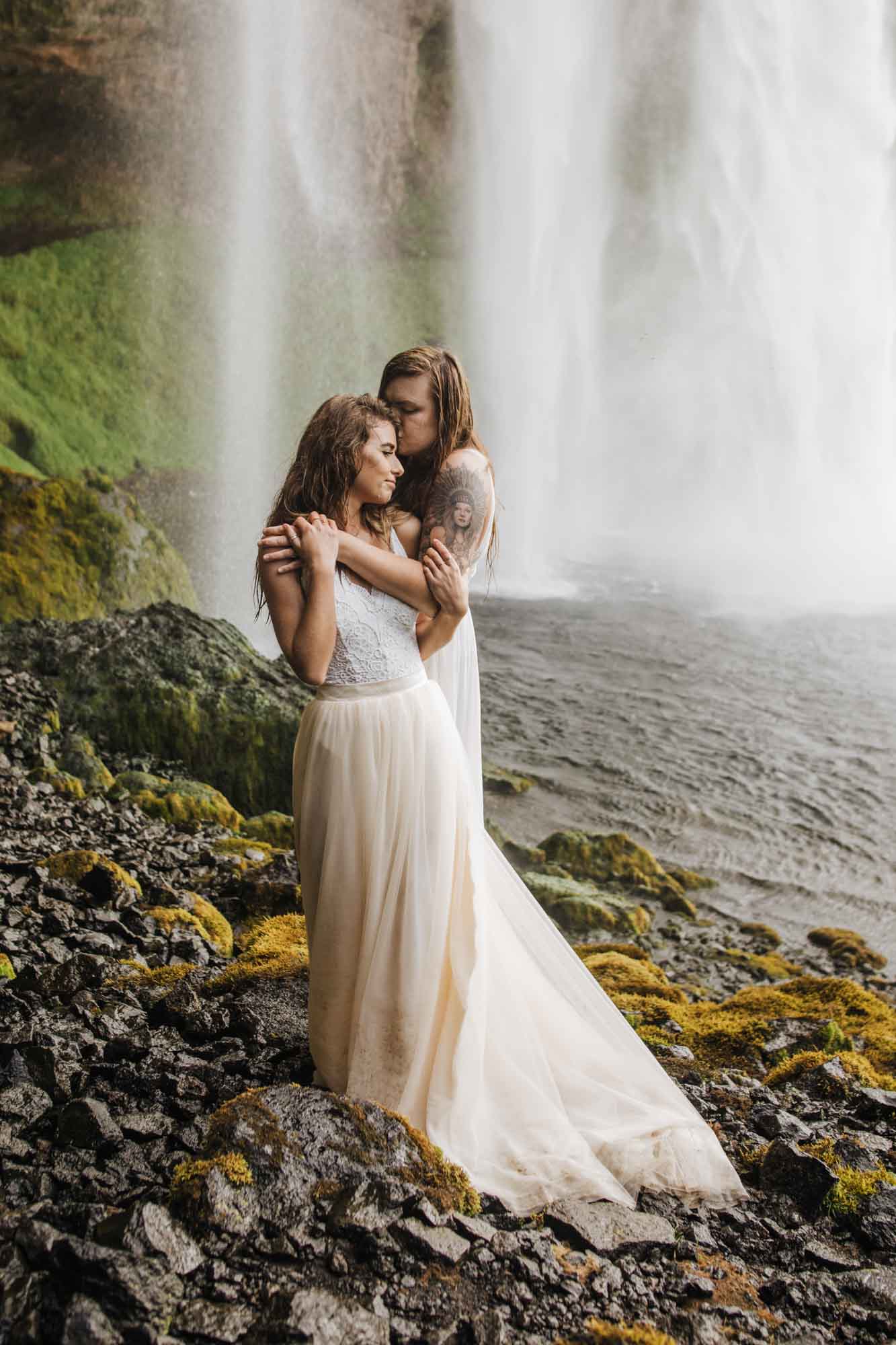 After an 18-month engagement, Cassidy and Hannah traveled from their home in West Hartford, Connecticut, to Iceland for an epic elopement. Their photographer Allie Dearie captured images of their love while the couple spent time together under massive cascading waterfalls and on the dark and moody beach.