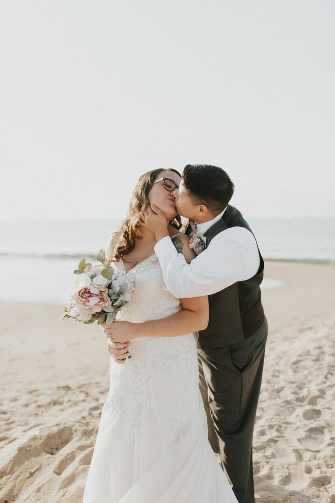 Cruise wedding with attendants in dusty rose gowns and brown suits