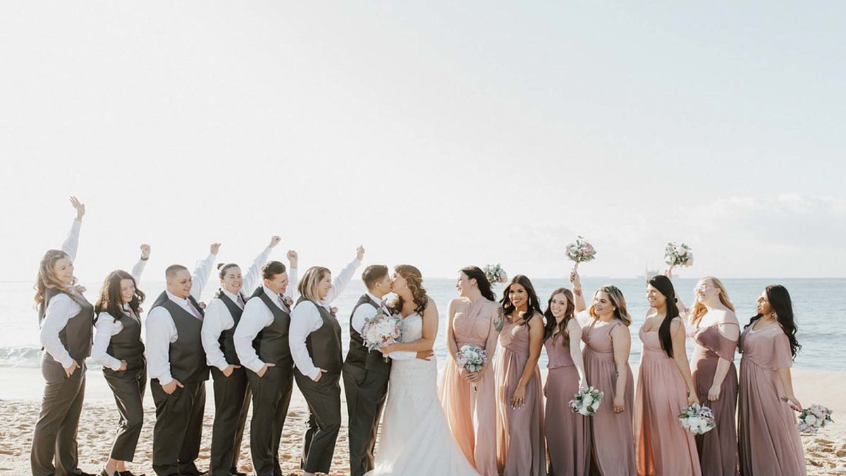 Cruise wedding with attendants in dusty rose gowns and brown suits