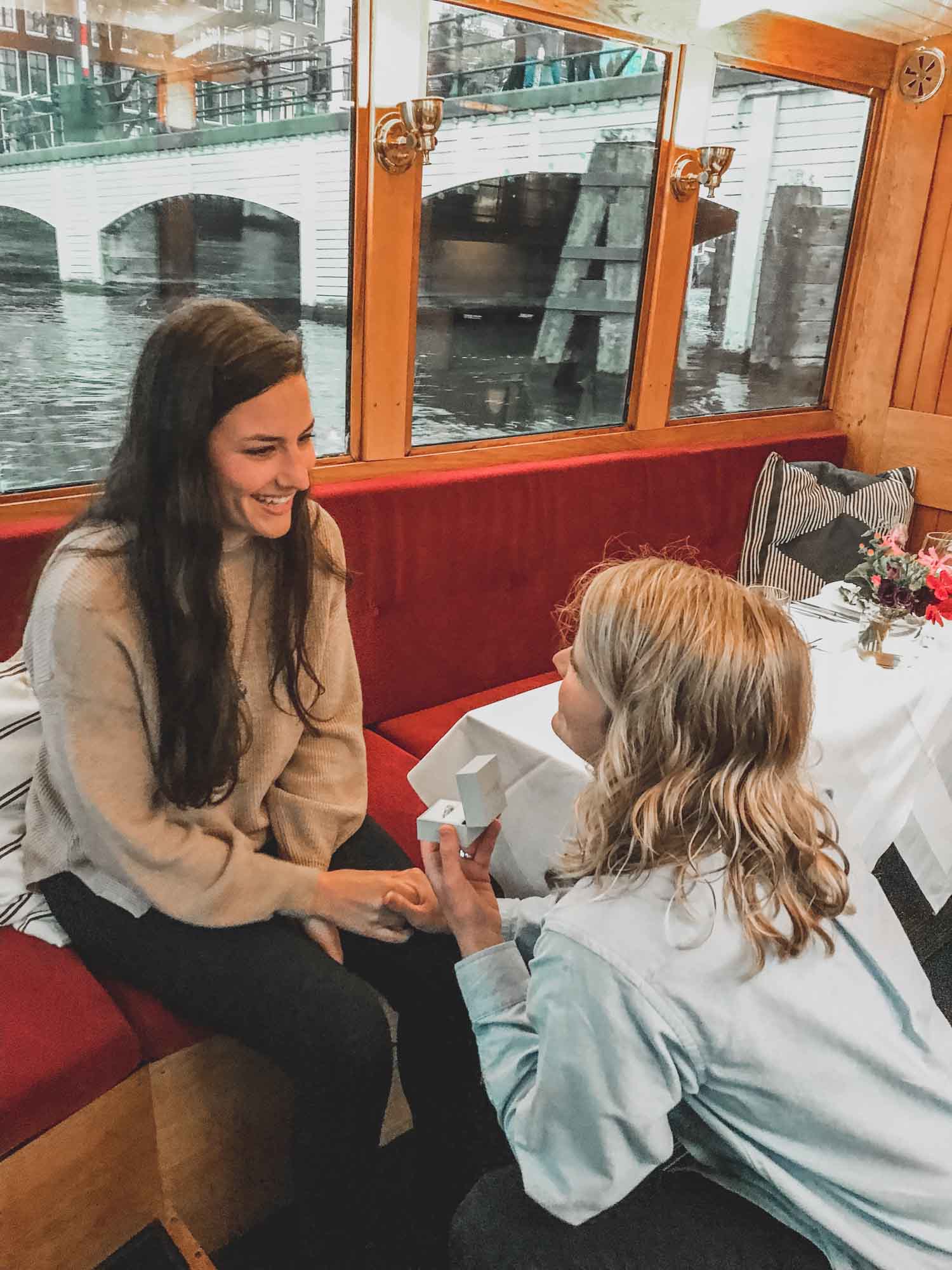 Dinner cruise proposal under Amsterdam's lucky Skinny Bridge| Big Little Amsterdam | Featured on Equally Wed, the leading LGBTQ+ wedding magazine