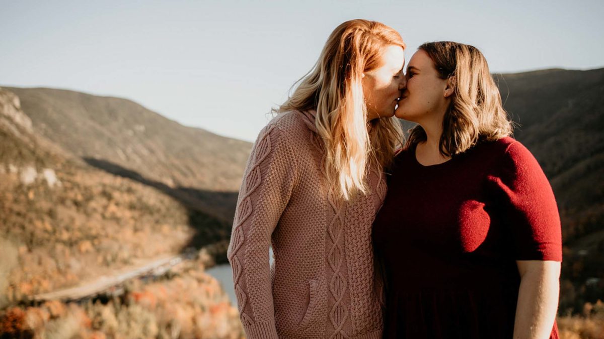 Sunny mountaintop engagement session after board game proposal