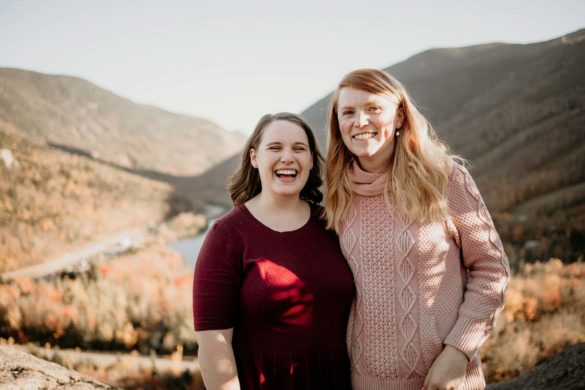 Sunny mountaintop engagement session after board game proposal