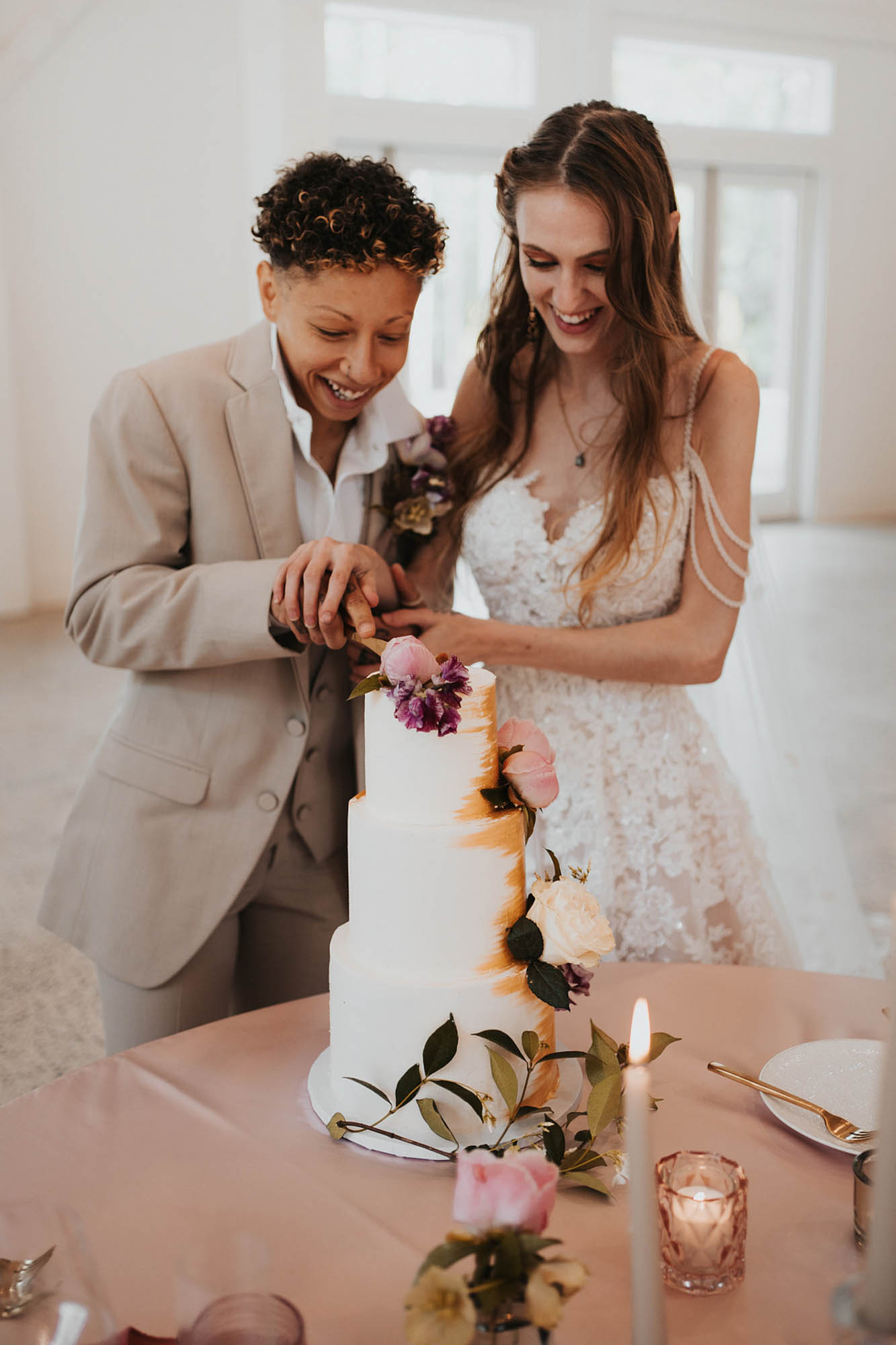 Chic barn wedding ideas with flower all and circular arch | Forest and Fog Collective | Featured on Equally Wed, the leading LGBTQ+ wedding magazine