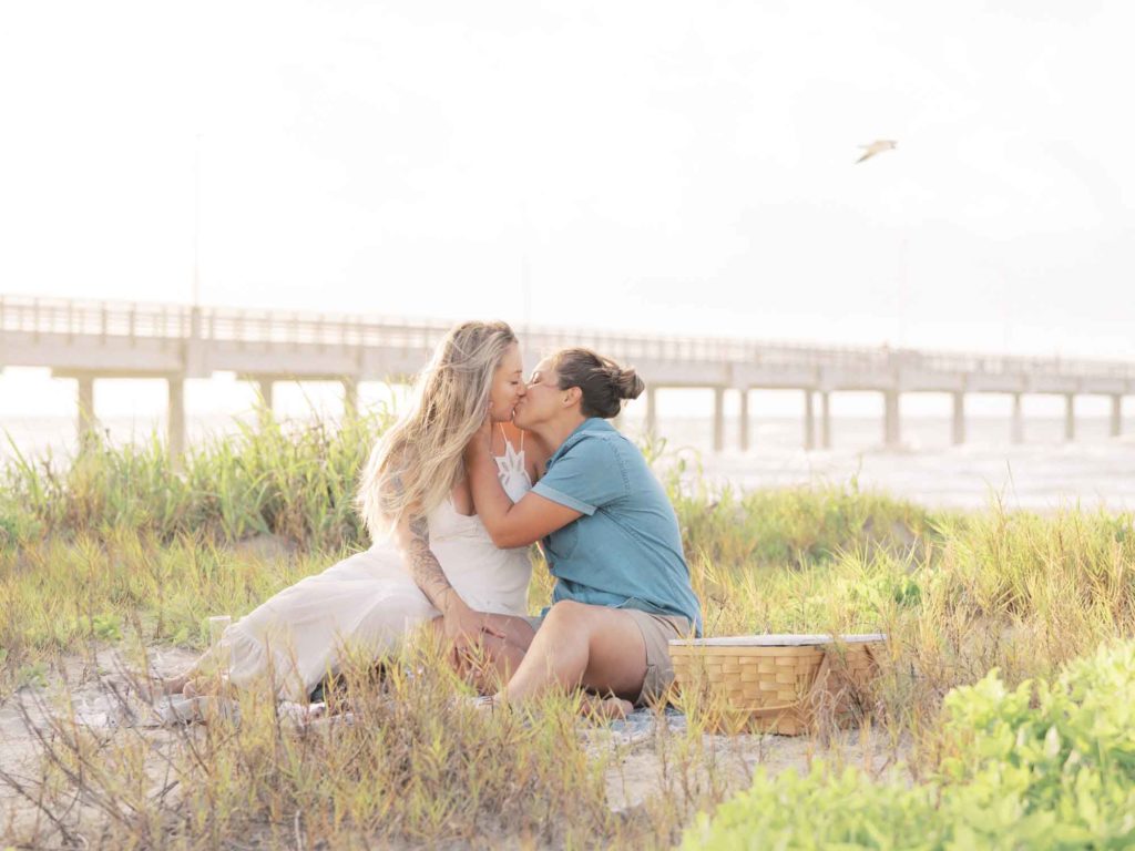 Glowing sunrise engagement session on the beach after Disney World proposal | Caitlin Rose Photography | Featured on Equally Wed, the leading LGBTQ+ wedding magazine