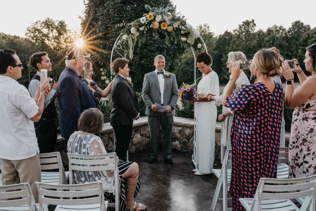 Relaxed and cozy Tennessee wedding with floral arch and Pride flags | Jeremy Gouge | Featured on Equally Wed, the leading LGBTQ+ wedding magazine
