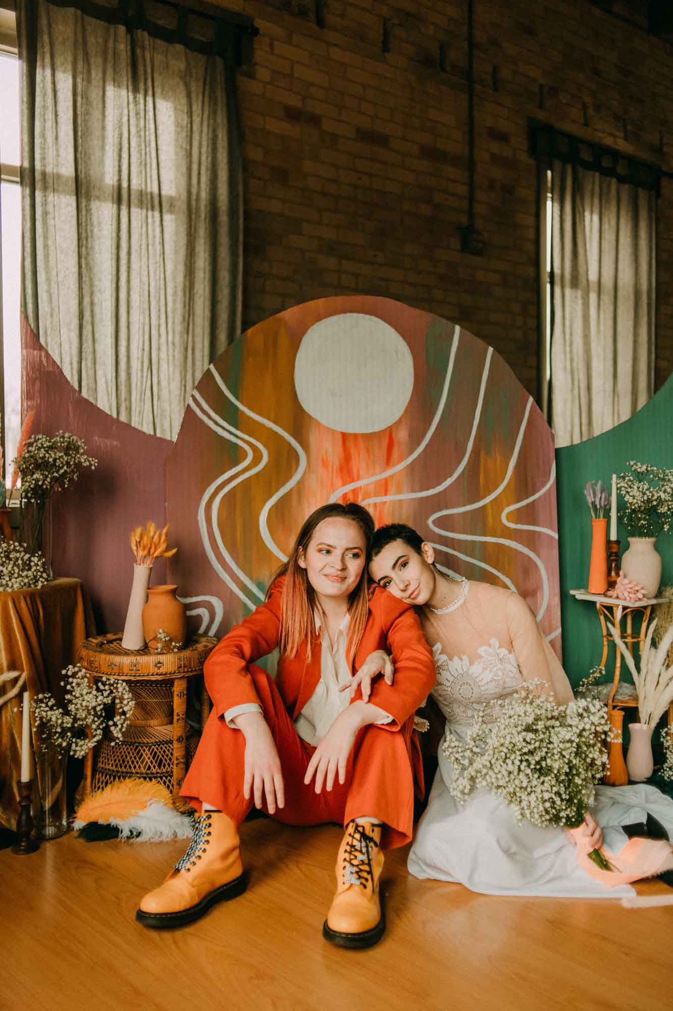 Colorful wedding inspiration with funky rainbow backdrop and bold orange suit | A, Lentz Photography | Featured on Equally Wed, the leading LGBTQ+ wedding magazine