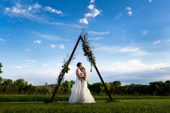 Outdoor Colorado wedding at historic cottage with triangle arch | Autumn Parry Photography | Featured on Equally Wed, the leading LGBTQ+ wedding magazine