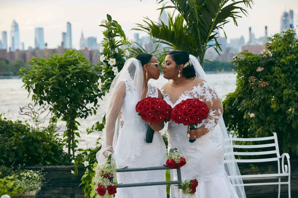 Sunset New York City wedding filled with red roses | Le Image | Featured on Equally Wed, the leading LGBTQ+ wedding magazine