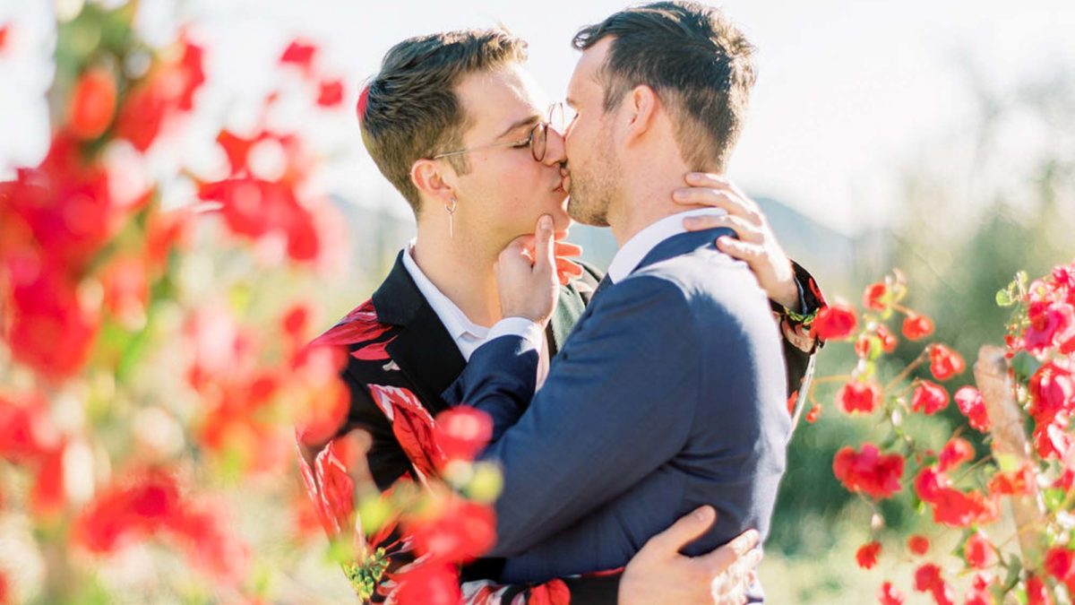 Desert LGBTQ+ wedding inspiration featuring native Arizona plants and a custom floral suit