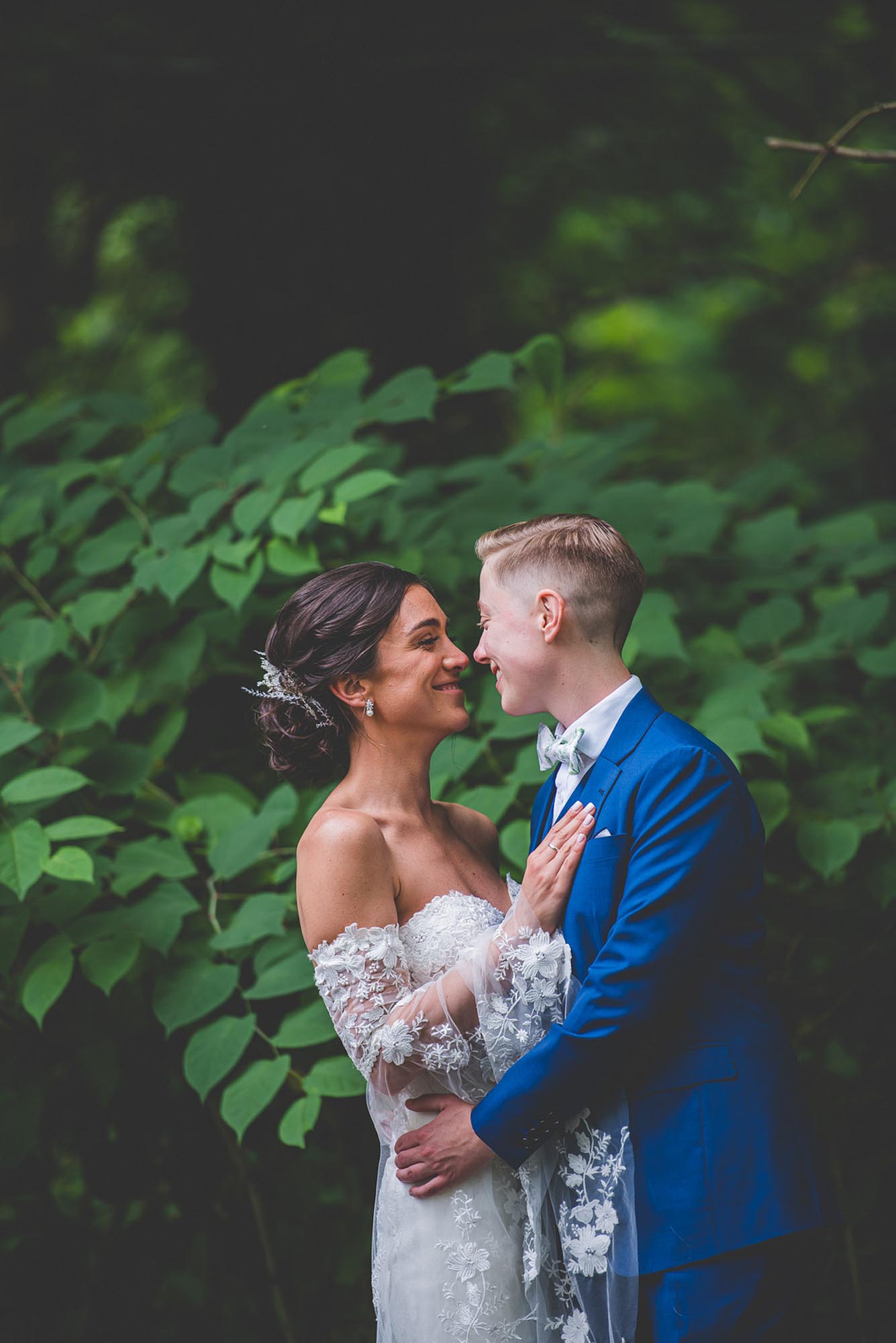 Philadelphia garden wedding with bold blue suit and cape sleeve gown | Beau Monde Originals | Featured on Equally Wed, the leading LGBTQ+ wedding magazine