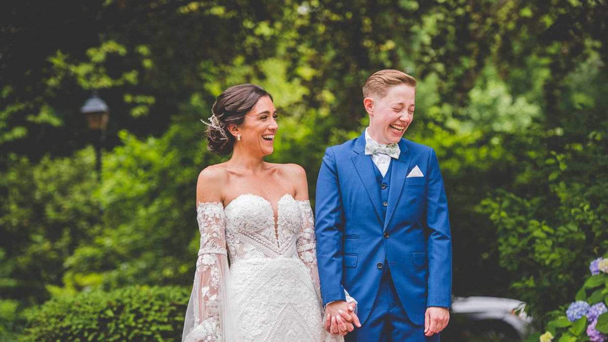 Philadelphia garden wedding with bold blue suit and cape sleeve gown