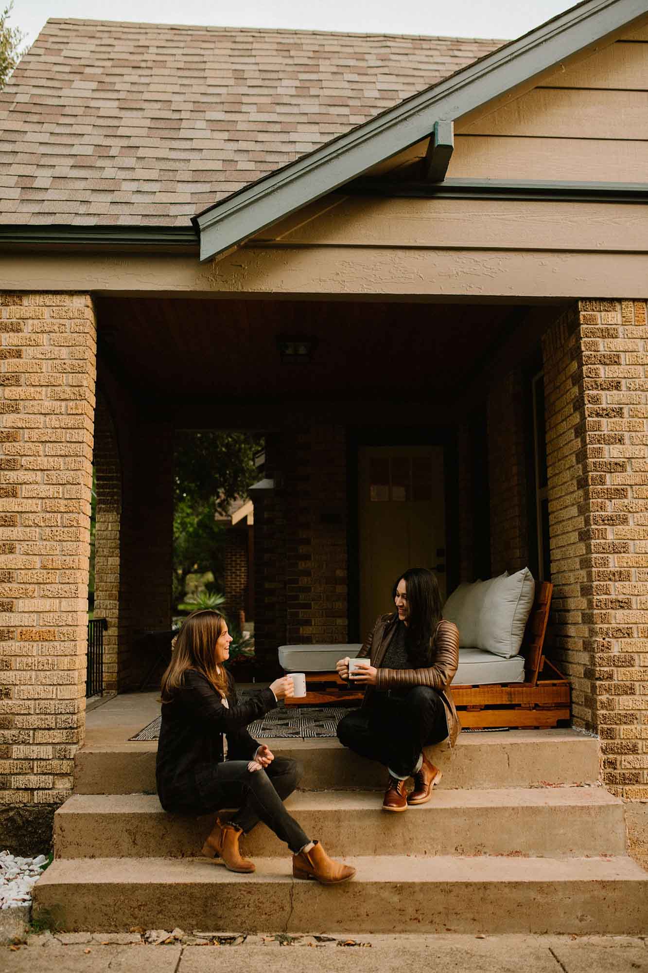 Cozy at home proposal with coffee and kisses | Whitney Rogers Photography | Featured on Equally Wed, the leading LGBTQ+ wedding magazine - coffee, house, leather jackets